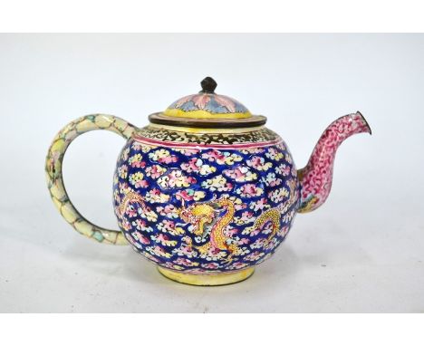 A Canton enamel teapot and associated domed cover with knop finial, decorated with dragons and cloud scrolls in pink, lemon, 