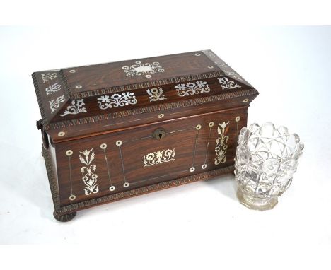 A Regency mother-of-pearl inlaid rosewood tea caddy of sarcophagus form, the interior with two lidded boxes centred by a circ