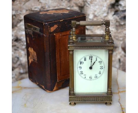 A 19th century brass cased 8-day carriage clock, the ceramic dial with arabic numerals, 13 cm h to/w a leather transit case
