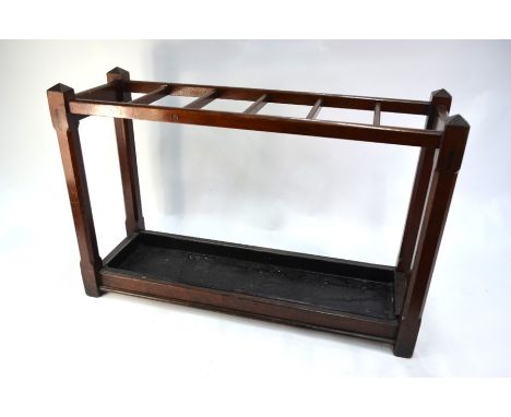 An antique mahogany six division stick stand with drip tray to base, 82 cm x 30 cm x 60 cm h