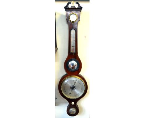 L Gionchio, Cork, a 19th century satinwood edged mahogany wheel barometer with circular silvered dial beneath a convex mirror