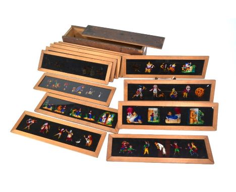 A set of twelve Victorian magic lantern slides, hand-painted on glass with ships, knights in armour, birds and animals, humor
