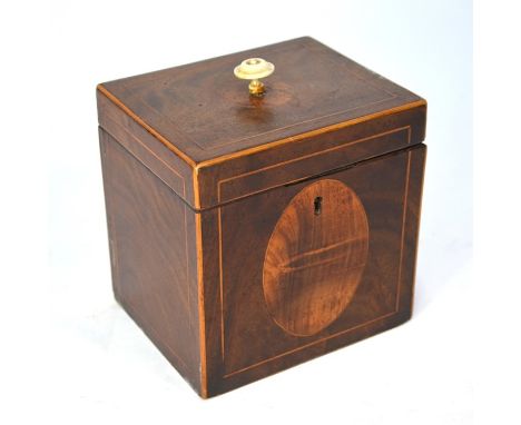 A Sheraton period mahogany cube tea caddy with figured oval medallion and boxwood stringing, 13 cm wideTurned bone top handle