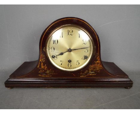 A Napoleons hat mantel clock with Chinoiserie decoration and Westminster chimes, with pendulum and key.Condition Report: Appe