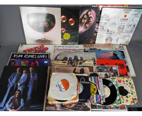 A collection of vinyl records 7" and 12" to include Deep Purple, The Rolling Stones, John Lennon, Status Quo and similar.Lot 