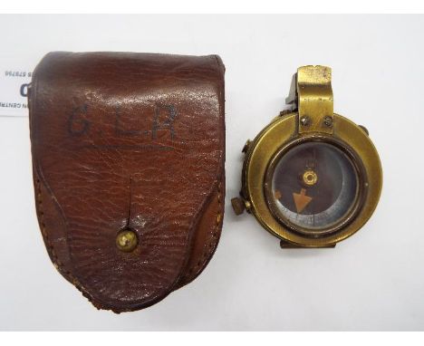 A British military brass compass scribed with crow's foot and leather case  Lot descriptions reflect the cataloguer's opinion