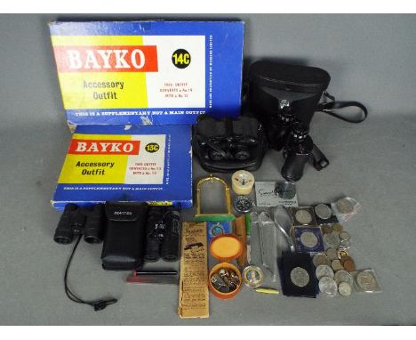 A mixed lot of collectables to include binoculars, vintage Bayko Accessory Outfits, commemorative coins, compass and similar.