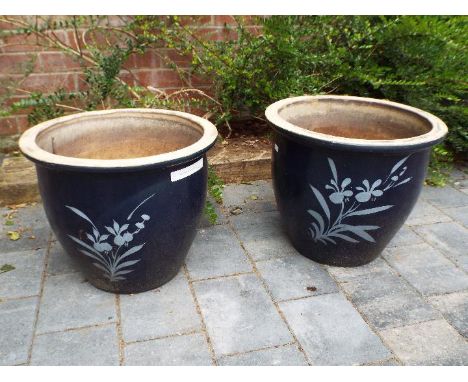 A pair of stoneware garden planters, Oxford blue with floral decoration, approx 33 cm (h) x 40 cm (diam).Both planters are in