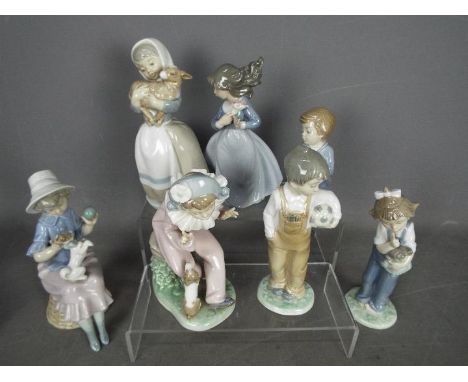 Nao - Seven figurines by Nao, predominantly of children, largest approximately 21 cm (h).Condition Report: The boy kneeling t