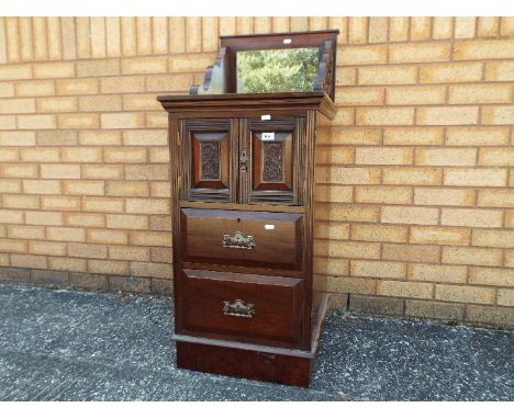 A mahogany commode with carved detail, brass drop handles, mirror top, approx 83 cm x 47 cm x 54 cm     Lot descriptions refl