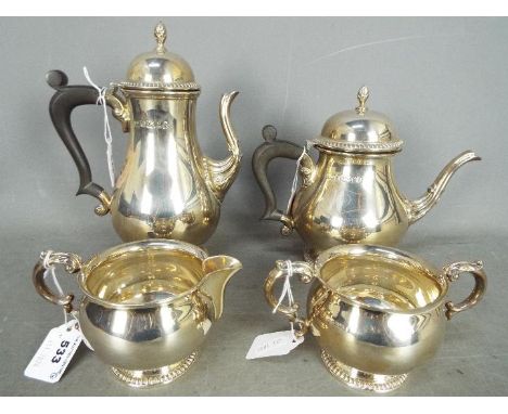 A hallmarked silver four piece tea set with gadrooned detailing, comprising teapot, milk jug, sugar bowl and water jug, Sheff