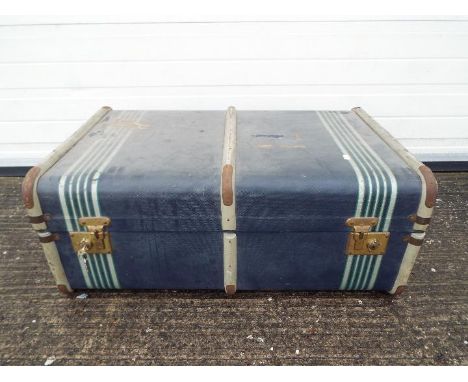 A vintage, wood bound shipping trunk.Lot descriptions reflect the cataloguer's opinion only and do not constitute a guarantee