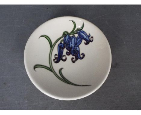 Moorcroft - a Bluebell Harmony ceramic coaster, approx 12 cm (d)Lot descriptions reflect the cataloguer's opinion only and do
