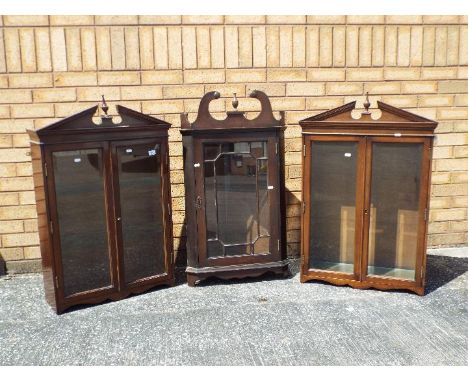A Georgian mahogany hanging corner cupboard with glazed panel door set beneath swan necked pediment, 95 cm (h) and two furthe