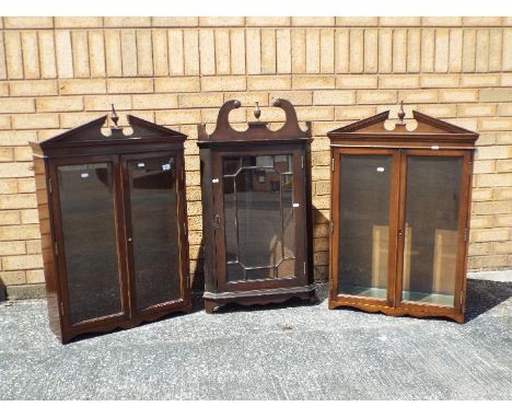 A Georgian mahogany hanging corner cupboard with glazed panel door set beneath swan necked pediment, 95 cm (h) and two furthe