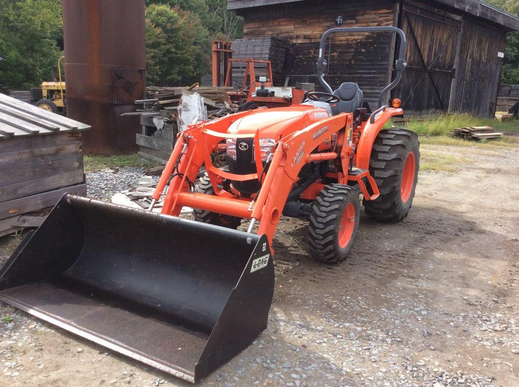 Kubota L5460HST tractor with LA1055 front loader with bucket attachment