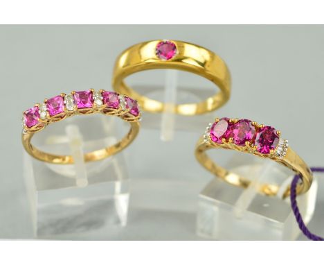 THREE 9CT GOLD PINK STONE GEM SET RINGS to include a single stone rub over set band, assessed as pink tourmaline, ring size U