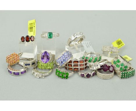TWENTY MAINLY GEM SET RINGS to include a three row garnet ring, a three stone ruby ring, an oval amethyst ring with rope twis