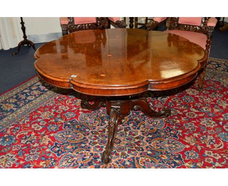 A VICTORIAN BURR WALNUT AND INLAID BREAKFAST TABLE with a wavy edged top on a scrolled tripod base, approximate diameter 120c