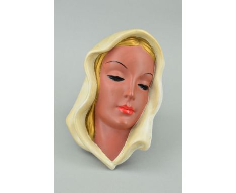 A GOLDSCHEIDER TERRACOTTA FACE MASK, modelled as a young woman's head wearing cream head scarf, black backstamp and original 