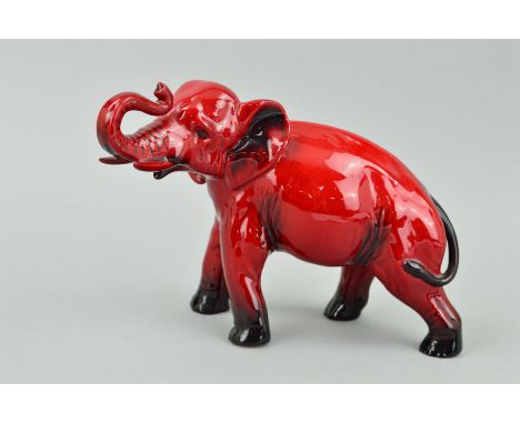 A ROYAL DOULTON FLAMBE ELEPHANT, trunk in salute, approximate height 13.5cm