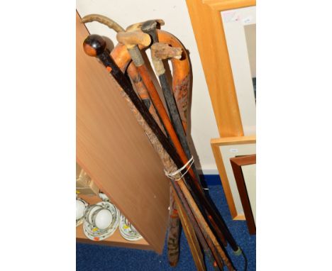 A BUNDLE OF WALKING STICKS, to include carved stick, horses head pommel (sd), etc