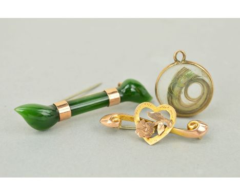 TWO EARLY 20TH CENTURY BROOCHES AND A HAIR PANEL PENDANT, the first brooch designed as an elongated carved jade panel, the se