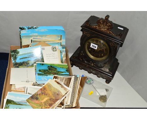 AN EBONISED WOODEN MANTEL CLOCK, with key and pendulum, with a collection of early to mid 20th Century topographical postcard
