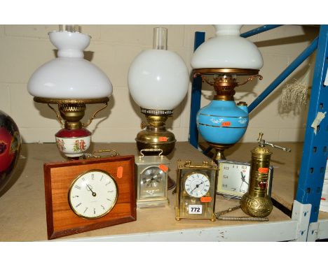 TWO OIL LAMPS AND A SIMILAR ELECTRIC EXAMPLE COMPLETE WITH GLASS SHADES, together with a vintage Chinese clock, quartz carria