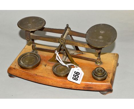 A SET OF POSTAL SCALES, with weights mounted on wooden plinth