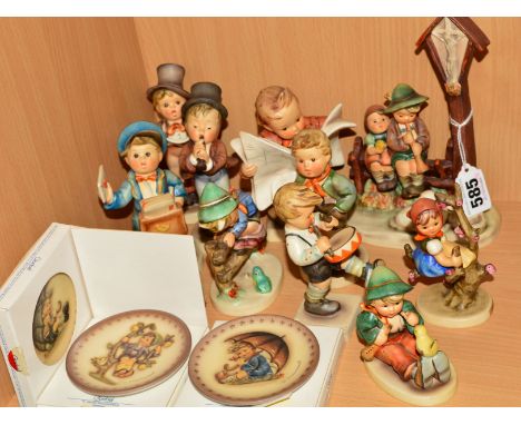 A GROUP OF HUMMEL FIGURES AND PLATES, to include 'Wayside Devotion' HUM28, 'Singing Lesson' HUM63, 'Serenade' HUM85, 'Trumpet