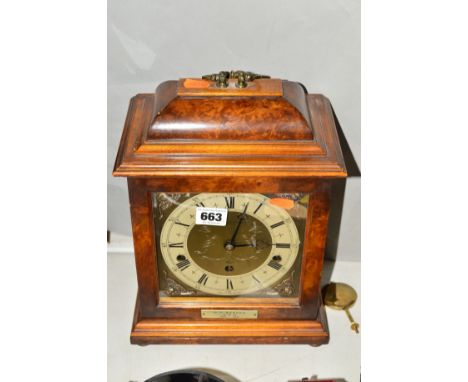 AN ELLIOT BRACKET CLOCK BY J.W.BENSON, LONDON, brass dial with Roman numerals, brass carry handle and on four bun feet, appro