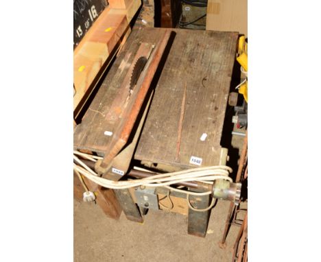 A VINTAGE TABLE SAW with cast iron base