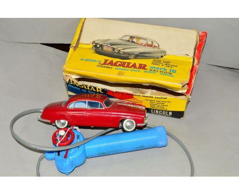 A BOXED LINCOLN INTERNATIONAL PLASTIC BATTERY OPERATED JAGUAR MARK 10 SALOON, No.7010, maroon plastic body with blue glazing 