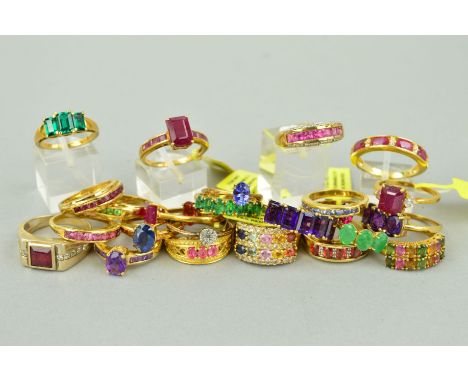 TWENTY FIVE MAINLY GEM SET GOLD PLATED RINGS to include a seven stone emerald ring, a three stone oval amethyst ring,  a two 