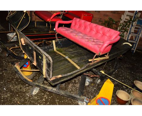 A VINTAGE TROIKA SLEIGH with red buttoned seat on large casters, approximate width 83cm x depth 210cm x height 115cm