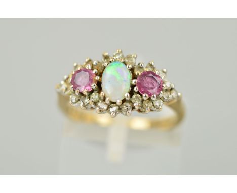 A GOLD OPAL, AMETHYST AND DIAMOND DRESS RING designed as a central opal cabochon flanked by circular amethysts all within a s