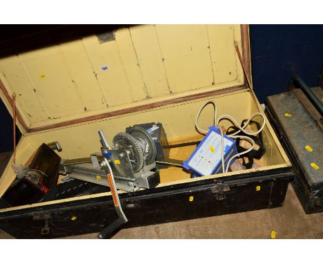 A LARGE VINTAGE RECTANGULAR DEED BOX containing a tow bar lock, tow bar winch, a metal toolbox and deed box containing variou