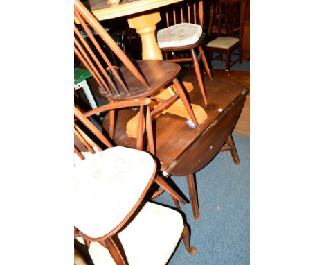 A DARK ERCOL ELM DROP LEAF DINING TABLE together with five stick back chairs including one carver (sd) (6)