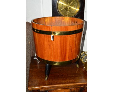 A 20TH CENTURY OAK AND BRASS COOPERED PLANTER on triple legs, approximate width 38cm x height 42cm together with a brown leat