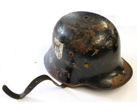 A German M18 Army Helmet, later painted black with SS decal, leather nine tongue liner and chinstrap af