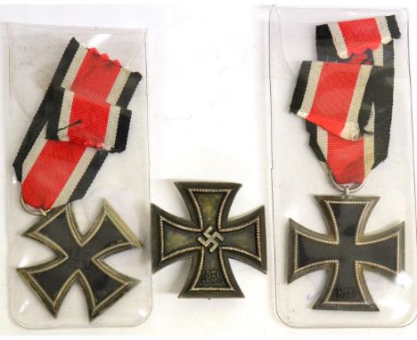 A German Third Reich Iron Cross, first class, non-magnetic, the pin stamped, ''51''; two further Second Class examples, one s