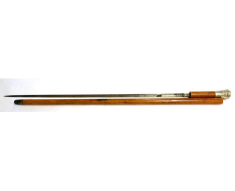 A Late 19th Century Malacca Swordstick, with 71cm plain leaf shape blade, the silver coloured metal pommel chased and repouss