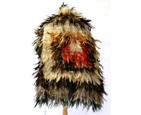 A Maori Korowai (Feather Cloak), of woven flax incorporating concentric bands of various blue, red, white and brown feathers,