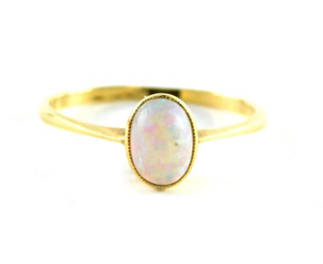 An opal dress ring, the oval opal in a raised basket on a yellow metal band stamped 18ct, ring size P, 1.8g all in.