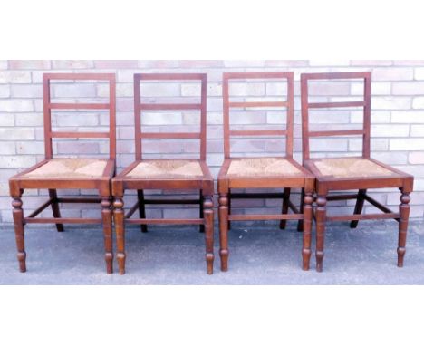A set of four late 19th/early 20thC mahogany ladder back dining chairs, each with a rush seat on turned legs.