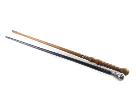 An ebonised walking cane, with silver knop and a turned wooden walking stick, 86cm high.