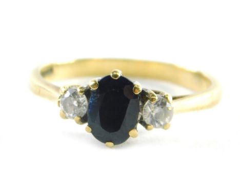 A 9ct gold dress ring, set with two CZ and a central dark blue imitation sapphire, ring size O, 2.2g all in. 