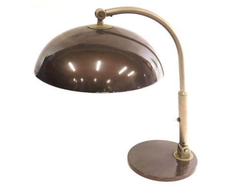 A vintage metal framed table lamp, with domed shade, in fawn, with articulated switch to the stem, on circular foot, unmarked