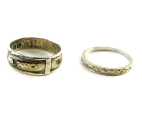 Two dress rings, comprising a silver buckle ring and an unmarked half hoop eternity ring, weighable silver 4g.  (2)